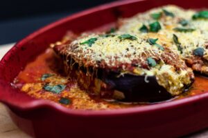 Eggplant Parmesan in a ceramic dish. what to get someone with a broken arm