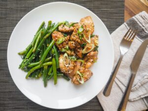 green beans and grilled chicken on a plate