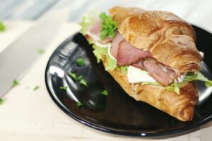 lunch meat sandwich on a croissant