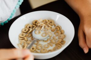 bowl of "O" shaped oat cereal and milk. cereal is one of the great meal train ideas for families