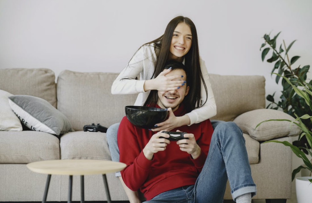girlfriend playing video games with her boyfriend on a sick day