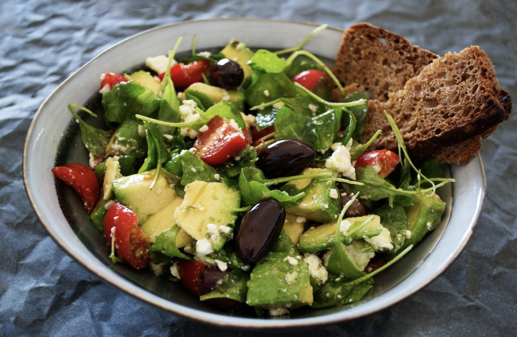 fresh green salad with shopped tomatoes, kalamata olivs, and crusty bread