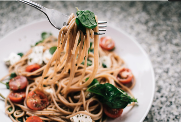spaghetti with fresh basil and tomatoes on a fork. recipes for meal train