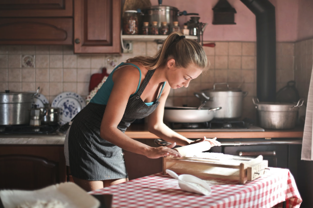 woman preparing fresh pasta in a home kitchen. Creating a meal train is one of the best gifts for friend with depression