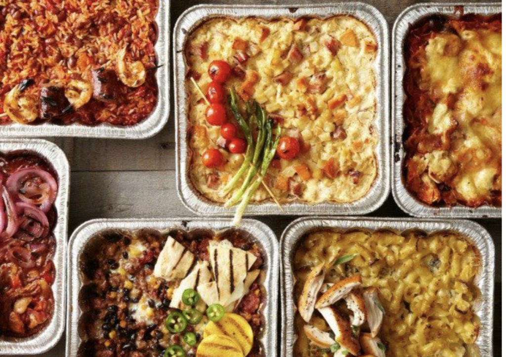 hot main and side dishes in foil containers. Takeout meals are a great way for busy people to participate in a meal planning calendar