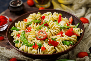 cold pasta salad, among the great summer meal train ideas. This dish contains fusilli pasta, tomatoes, asparagus, and sweet pepper