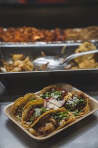 plate of various tacos assembled from a taco bar. one of our favorite meal train food ideas