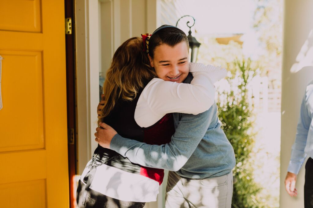 a person greeting their loved one at the door with a hug. how to support someone with serious illness