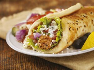 chicken, cheese, spices, and vegetables wrapped in a pita.