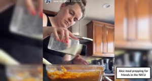 Alex meal prepping for friends in the NICU. A woman stands in her kitchen pouring seasoning into a bowl of mixed ingredients.