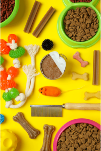 a top view of pet toys, food, and supplies on a yellow background. vital supplies for pet care during emergency